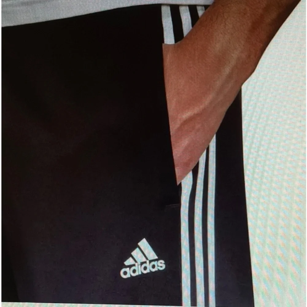 Adidas Men’s Joggers. Blue/grey color with black stripes.